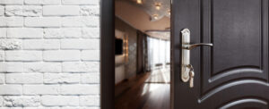 Half opened door to a house showing door handle and door lock 1