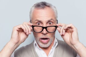How to Identify Pet Damage in Your Rental Property 7 surprised old man taking off and on his glasses